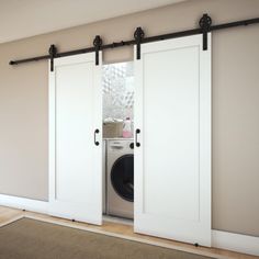 an open door to a washer and dryer in a room