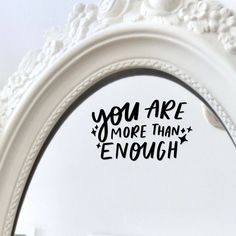 a mirror with the words you are more than enough written in black ink on it