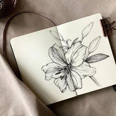 an open notebook with a flower drawn on it