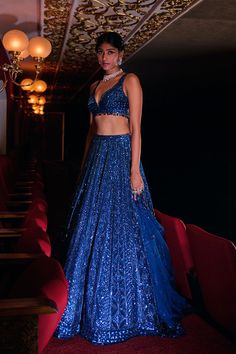 This lehenga set features all over tonal sequin embroidery in a geometric pattern. The ensemble is paired with a strappy blouse and a matching net dupatta.From Seema Gujral’s Night at the Opera collectionDELIVERY TIMEPlease wait 8-12 weeks for your outfit to arrive.FABRIC DETAILSNetProfessional cleaning only. Blue Sequin Lehenga, Lehenga Blue, Royal Blue Lehenga, Strappy Blouse, Sequin Lehenga, Sheer Dupatta, Seema Gujral, Leaf Sleeve, Reception Outfits