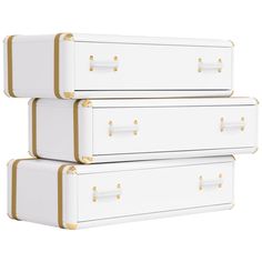 three white suitcases with gold handles are stacked on top of each other in front of a white background