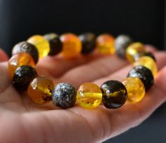 Handmade Baltic Amber Bracelet This particular bracelet is made of multicolored natural baltic amber. Baltic amber stretch bracelet - stones are assembled on two rubber strings. Just simple elegant bracelet! Length: 17/18 cm - 6,7/7,1"- bracelet is stretch Weight: 18g Amber beads are about: 13mm / 0,51" If you search for harmony, empowerment and originality offered by nature you must reach for the beautifully handcrafted stone pieces. Your bracelet will come carefully wrapped in an eco-friendly gift box. Positive Energy Crystals, Earthy Jewelry, Baltic Amber Jewelry, Fine Jewelery, Amber Bracelet, Summer Bracelets, Natural Amber, Amber Beads, Elegant Bracelet