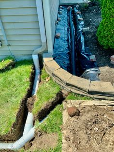 an image of a house that is under construction with pipes going through the ground and water coming out of it