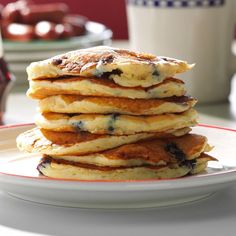 a stack of pancakes sitting on top of a white plate