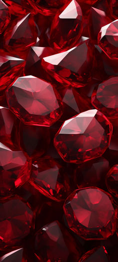 many red diamonds are scattered together on the ground in this close up photo, with one large diamond surrounded by smaller ones