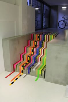 an art installation with multicolored lines on the floor