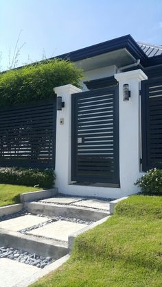 a black and white house with steps leading up to it