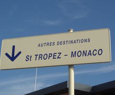 a white street sign sitting on top of a metal pole