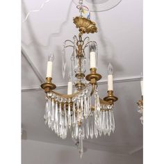 an antique chandelier hanging from the ceiling