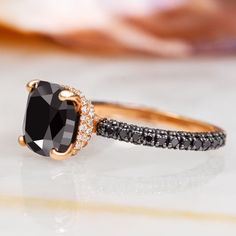 a black and white diamond ring on top of a table