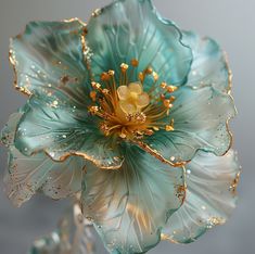 a blue flower with gold stamens on it