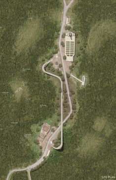 an aerial view of a winding road in the woods