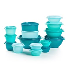 blue glass dishes stacked on top of each other in different shapes and sizes with lids