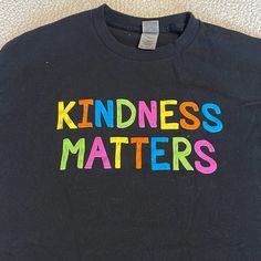 Gilden T-Shirt With Kindness Matters On The Front. Short Sleeves. Never Worn. Smoke Free/Pet Free Home. Fun Black Tops With Screen Print, Fun Black Tops With Text Print, Fun Black Top With Text Print, Fun Black Slogan Top, Fun Black Tops With Letter Print, Fun Black Shirt With Screen Print, Fun Black Shirt With Letter Print, Black Relaxed Fit Fun T-shirt, Fun Black Relaxed Fit T-shirt