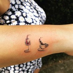 a woman's arm with two coffee tattoos on it