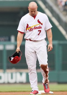 a baseball player holding a catchers mitt on top of a field