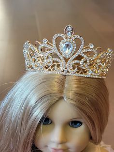 a doll with blonde hair wearing a tiara