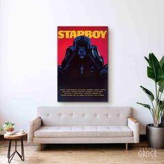 a star wars poster hangs on the wall above a couch