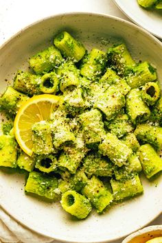 a white bowl filled with broccoli covered in pesto