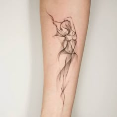 a woman's arm with a line work tattoo on the left side of her leg