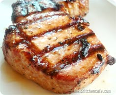 two pieces of meat sitting on top of a white plate