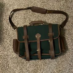 This Is A Green Canvas And Leather Briefcase. Green Vintage Satchel For Travel, Classic Coated Canvas Shoulder Bag With Luggage Sleeve, Rectangular Travel Cases With Leather Trim, Luxury Rectangular Satchel For School, Classic Satchel With Large Capacity For Errands, Classic Large Capacity Coated Canvas Satchel, Luxury Rectangular Shoulder Bag For School, Classic Rectangular Coated Canvas Shoulder Bag, Classic Rectangular Saddle Bag For Errands