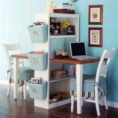 a laptop computer sitting on top of a wooden desk next to a white chair and table