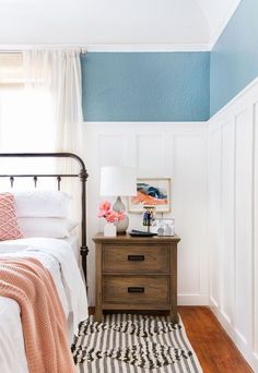 a bedroom with blue and white paint on the walls