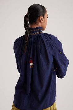 Navy blue top featuring hand-smocking on the neck, bishop sleeves, folk embroideries, and embroidered front button detailing. - Aza Fashions Bohemian Tops With Smocked Cuffs And Bishop Sleeves, Bohemian Tops With Bishop Sleeves And Smocked Cuffs, Folk Style Long Sleeve Top With Embroidered Cuffs, Embroidered Cotton Bishop Sleeve Top, Embroidered Bishop Sleeve Cotton Top, Blue Cotton Blouse With Smocked Cuffs, Navy Blue Top, Top For Women, Blue Top