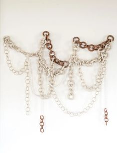 a white wall with chains hanging from it's sides