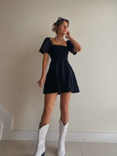 Dress With Cowboy Boots Concert, Concert Cowboy Boots Outfit, Slip Dress With Cowgirl Boots, Black Dress And White Boots, Cowgirl Outfits Brown Boots, Black Dress For Concert, Colored Cowboy Boots Outfit, Cute Cowgirl Dress Outfits, All Black Cowboy Boots Outfit