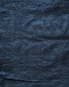 an old wrinkled blue paper textured with dark waxe and crinkled edges