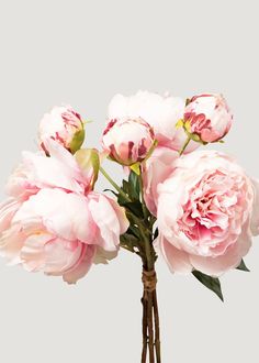 some pink flowers are in a vase on a table