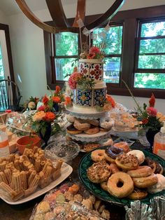 a table filled with lots of different types of food and desserts on top of it