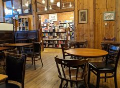 a library with tables, chairs and bookshelves filled with lots of books in it