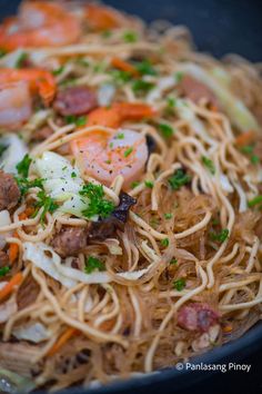 pasta with shrimp, carrots and parsley in a skillet