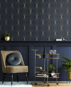 a living room with blue walls and gold accents on the wall, two chairs and a table