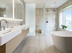 a large bathroom with two sinks and a bathtub