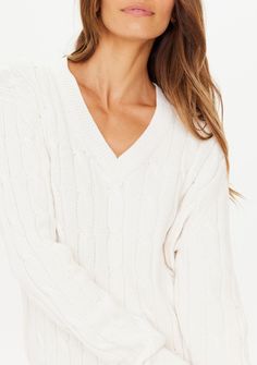 DETAILS: Channel a casual kind of luxury with our Seymour Knit Crew. Knit sweater V-Neck Relaxed, cropped crew in creme Ribbed cuffs, hem and necklines Versatile styling Embroidered arrow logo at back neck Fabric: 1 00% organic cotton cable knit sweater SIZING: Relaxed fit True to size Model is 170cm/5ft 7in tall and wears an AU XS which is a UK 8, US 4 and EU 34 CARE: Gentle Cold Machine Wash Separately. Do Not Soak, Bleach Or Wring. Reshape Whilst Damp. Dry Flat in Shade. Do Not Tumble Dry. Co White V-neck Sweater With Ribbed Cuffs, White Knit V-neck Sweater With Ribbed Cuffs, Cream Cashmere V-neck Sweater, Cream V-neck Sweater With Ribbed Cuffs, Cream Cotton V-neck Sweater, Cotton Cable Knit Sweater, Arrow Logo, Jeans Size Chart, Beauty Body