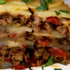 a close up of a plate of food with lasagna and cheese on it