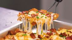 a close up of a pizza in a pan with cheese and bacon toppings on it