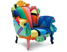 an upholstered chair made out of multicolored fabric and glass beads on the legs