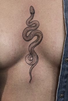 a woman's chest with a snake tattoo on the left side of her breast