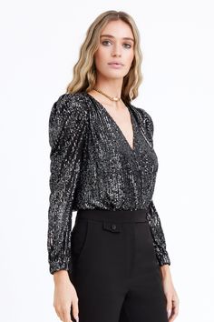 A must-have in every wardrobe, our Lala Sequins Bodysuit hugs your body and gives shape making it the perfect choice to complete a killer look. Featuring a plunging neckline and puffed sleeves. Create a stylish outfit with your favorite pair of jeans or dressed it up with leather pants. Sequin bodysuit Deep v-neck Long sleeves Elastic cuffs Puff sleeves Bikini bottom Imported Length: 17 1/2 Model is wearing a size small Style #: F229T9257 Knitted Top Outfit, Sequin Bodysuit, Metallic Knit, Sequin Jacket, Wedding Sale, Holiday Outfit, Stylish Outfit, Puffed Sleeves, New Arrival Dress