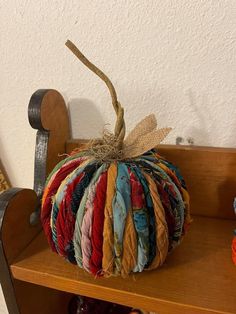 a colorful pumpkin sitting on top of a wooden shelf