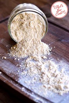 a jar filled with white powder sitting on top of a wooden table