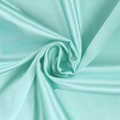 Stretch charmeuse satin fabric is composed of 97% polyester and 3% lycra with a 56/58 width. This lightweight fabric has smooth and silky to the touch. It has a tightly knit weave and slight 2-way vertical stretch, making it extremely versatile in application. The combination of these characteristics create and elegant flow when used for draping. This fabric has a beautiful shiny satin side with a modest matte finish on the back, allowing for a very elegant and high-end look. This fabric is perf Blue Satin Dress For Wedding With Satin Finish, Blue Satin Dress For Wedding, Stretch Satin Fabric, Stretch Satin, Green Satin, Blue Satin, Fabric Shop, Tiffany Blue, Dance Wear