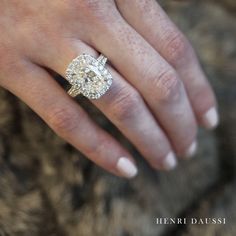 a woman's hand with a diamond ring on it