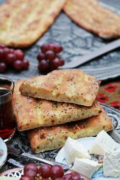 grapes, cheese and crackers are on a plate