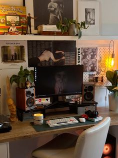 a desk with a computer and speakers on it